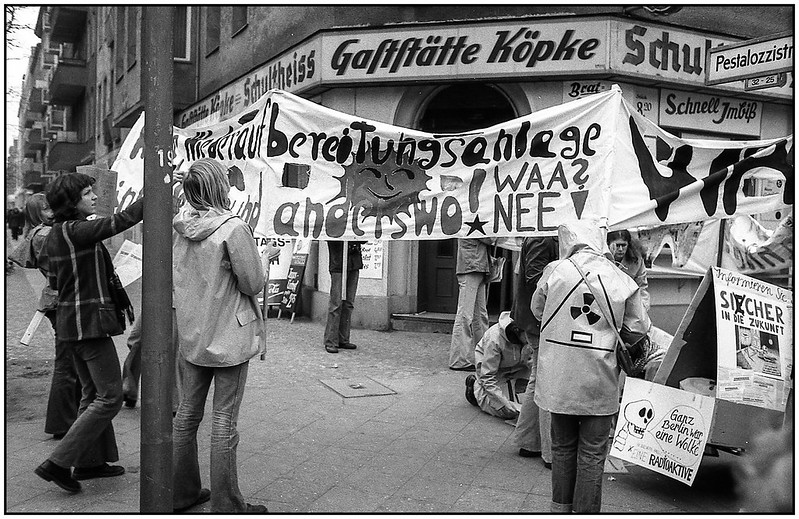 Youngish activists are on the street with signs and banners containing anti-nuclear power slogans in German.